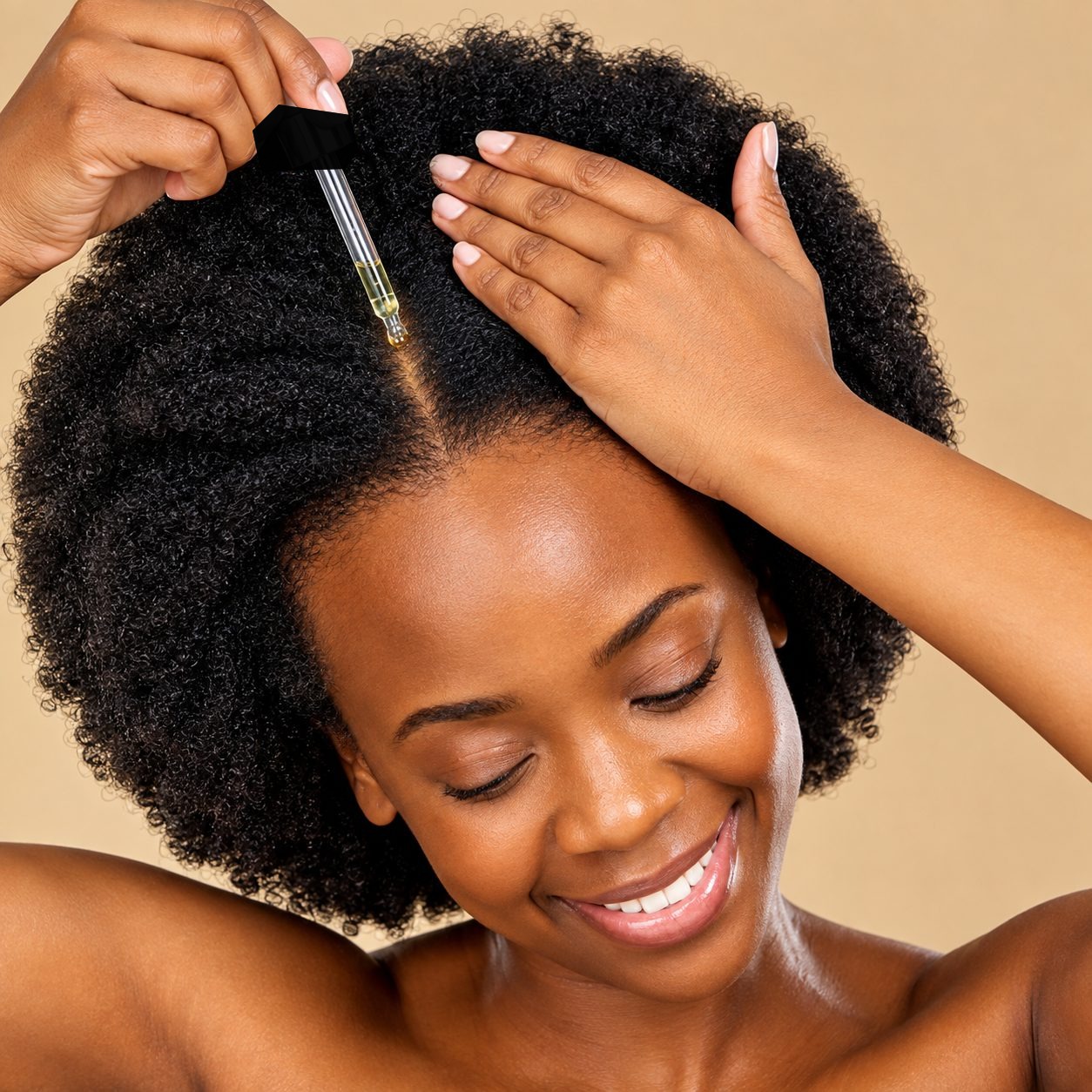Applying Chebe hair oil drop by drop to natural afro hair for deep moisture